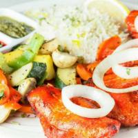 Chicken Tikka · Gluten free. Boneless chicken marinated in yogurt, herbs, saffron and spices. Served on a be...