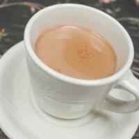 Chai Tea (Iced) · An ancient tea of India, made with black tea, milk, cardamom, cloves, fennel, and sugar.