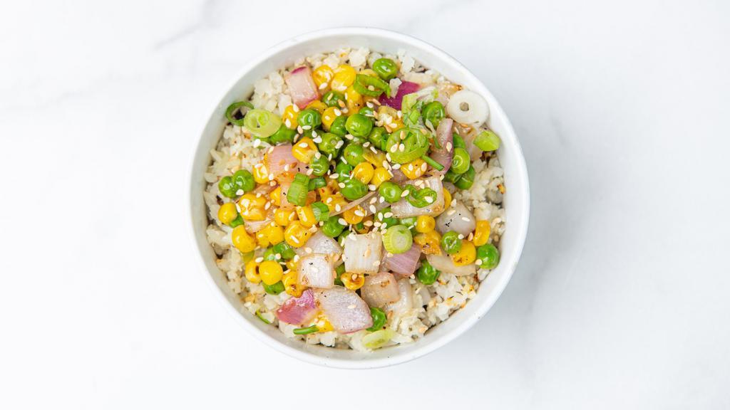 Cauliflower Fried Rice · Roasted cauliflower rice, peas, corn, green onions, and sesame seeds with our house-made ginger garlic sauce and a protein of your choice. (gluten-free)