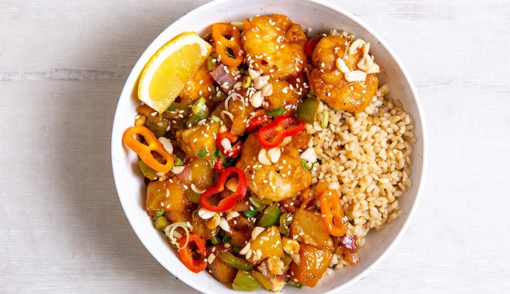 Hollywood Sweet And Sour Tofu · Sesame tofu with chili-dusted pineapple, peppers & onions, roasted salt-free peanuts, green onions, sesame seeds, and our house-made sweet and sour sauce.  Served with a lemon wedge, and a base of your choice. (gluten-free)