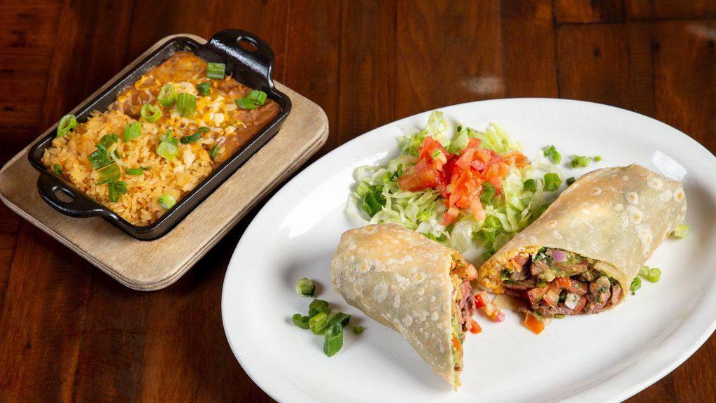 Carne Asada Burrito · Grilled steak, guacamole, pico de gallo, cheese, served with rice and beans.
