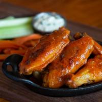 Chicken Wings · choose: garlic parmesan, traditional buffalo, or ginger soy. served with glazed carrot, cele...