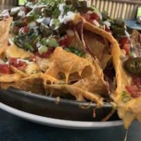 One Layer Nachos · Tortilla chips, jack and cheddar, jalapeños, green onions, hand cut pico, salsa roja and lim...