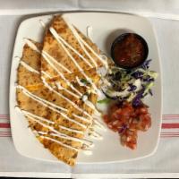 Tiki Quesadilla · Grilled tortilla with jack and cheddar cheeses, sautéed peppers and onions, lime créma and f...