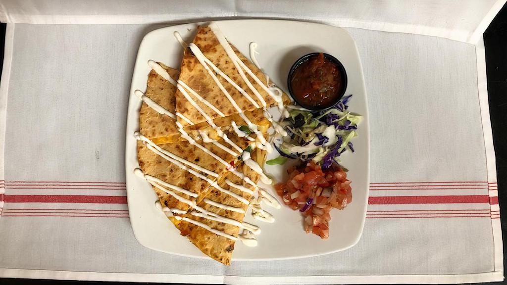 Tiki Quesadilla · Grilled tortilla with jack and cheddar cheeses, sautéed peppers and onions, lime créma and fresh salsa roja.