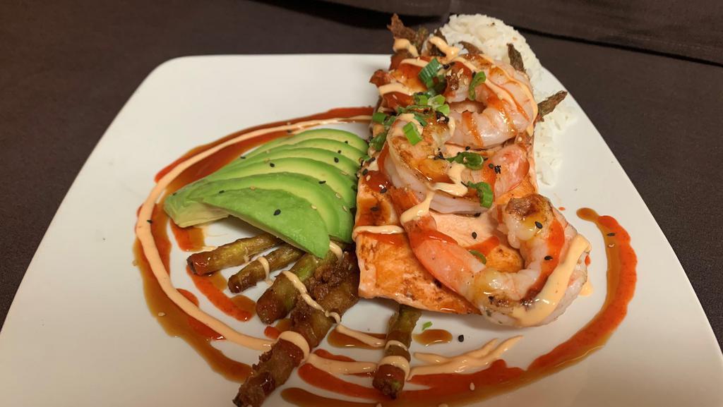 Firecracker Salmon · Grilled fillet set on jasmine rice and finished with tempura asparagus, char grilled prawns, fresh avocado, teriyaki, spiked aioli, green onion and sriracha sauce.