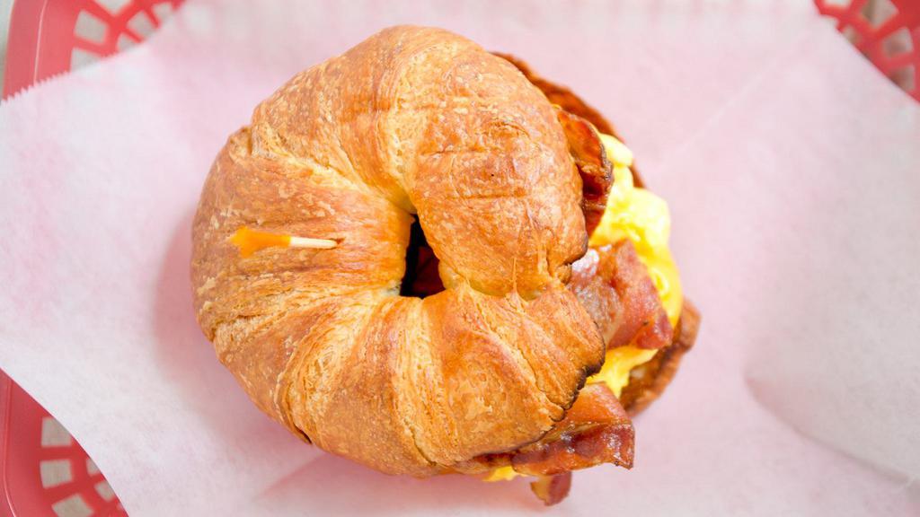Croissant Or English Muffin · Scrambled eggs topped with your choice of ham, bacon, sausage or chicken and your choice of cheese on a toasted croissant or English muffin.
