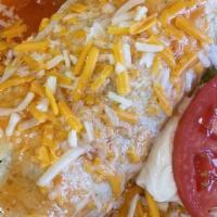 Wet Burrito · Popular item. Rice, beans, ranchera salsa, cheese, lettuce, tomato, sour cream, meat.