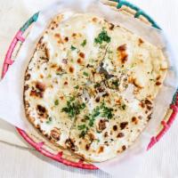 Garlic Naan · Naan with a subtle touch of garlic and cilantro.
