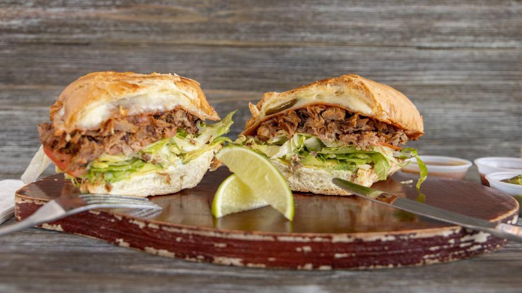 Torta · Choice of meat, refried beans, shredded melted cheese, jalapenos, iceberg lettuce, sliced avocado, sour cream, tomato, and telera roll.