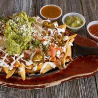 Super Nachos · Local corn tortilla chips, choice of meat, shredded cheese, chile cheese sauce, refried bean...