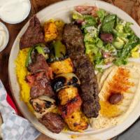 Mix Grill Plate · Three skewers of kababs: chicken, beef, and kafta, served with rice, hummus, Greek salad, pi...
