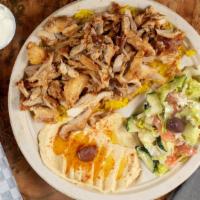Chicken Shawarma Plate · Marinated grilled chicken breasts served over rice with salad and garlic dip.