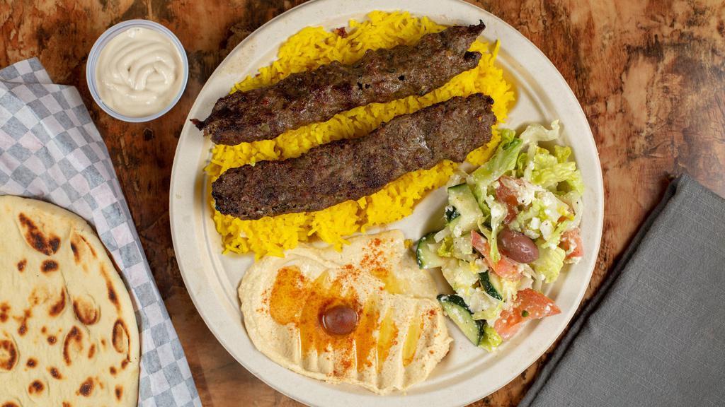 Kafta Kabab · Skewered seasoned ground beef charbroiled to perfection served over rice with salad & hurm,us.