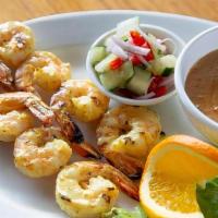 Satay Prawns. · Barbecued Prawns marinated in coconut milk and a mixture of Thai spices.  Served with our fa...
