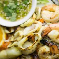 Talay Paow · Combination of grilled seafood: jumbo prawns, scallops, calamari and mussels. Served with fr...