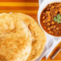 Chole Bhatura · Chole is a spiced tangy chickpeas curry and Bhatura is a soft and fluffy fried leavened bread