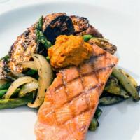 Grilled King Salmon · Gluten-free. Harissa roasted fingerlings, roasted spring vegetables, romesco