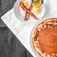 The Daewoo Two · 2 of our giant buttermilk pancakes served with 2 eggs cooked to order and choice of bacon or...