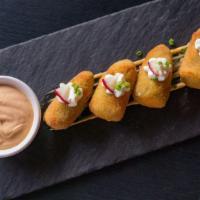 Jalapeño Poppers (4 Pcs) · Spicy jalapeños stuffed with cheese, lightly breaded and dried until crisp and golden on the...