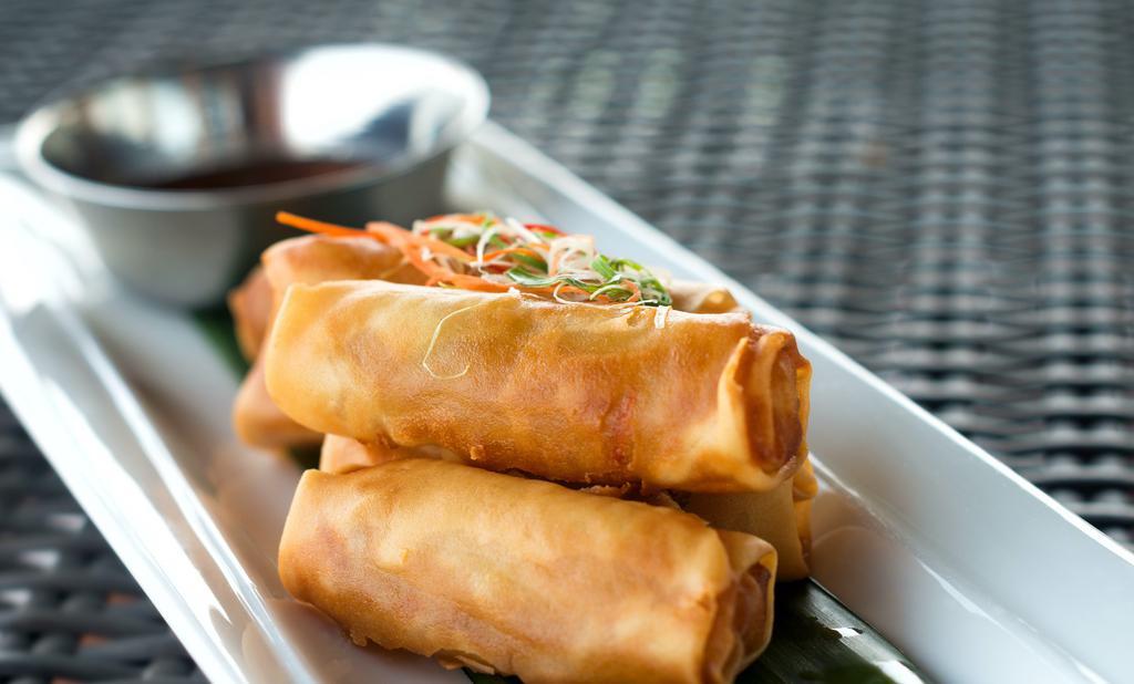 Vegetable Spring Rolls (5 Pcs) · Rice paper stuffed with finely chopped veggies including carrots and cabbage with garlic and ginger. Fried until crisp and browned on the outside.