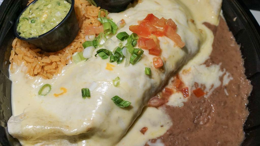 Burrito Jalisco · Steak or chicken seasoned with pico de gallo, topped with cream sauce, tomatoes, onions, guacamole, and sour cream.