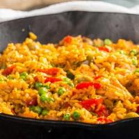 Arroz Con Pollo · Chicken with rice. Boneless breast of chicken on a bed of rice. Covered with special sauce. ...