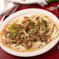 Bistec Encebollado · Grilled steak mixed with onions and jalapeños.