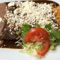 Enchiladas De Mole Oaxaqueño · Chicken, beef, or cheese served with rice, beans, and queso fresco on top.