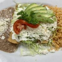 Tacos Dorados · 4 rolled crispy tacos stuffed with tender shredded chicken or beef topped with lettuce, sour...