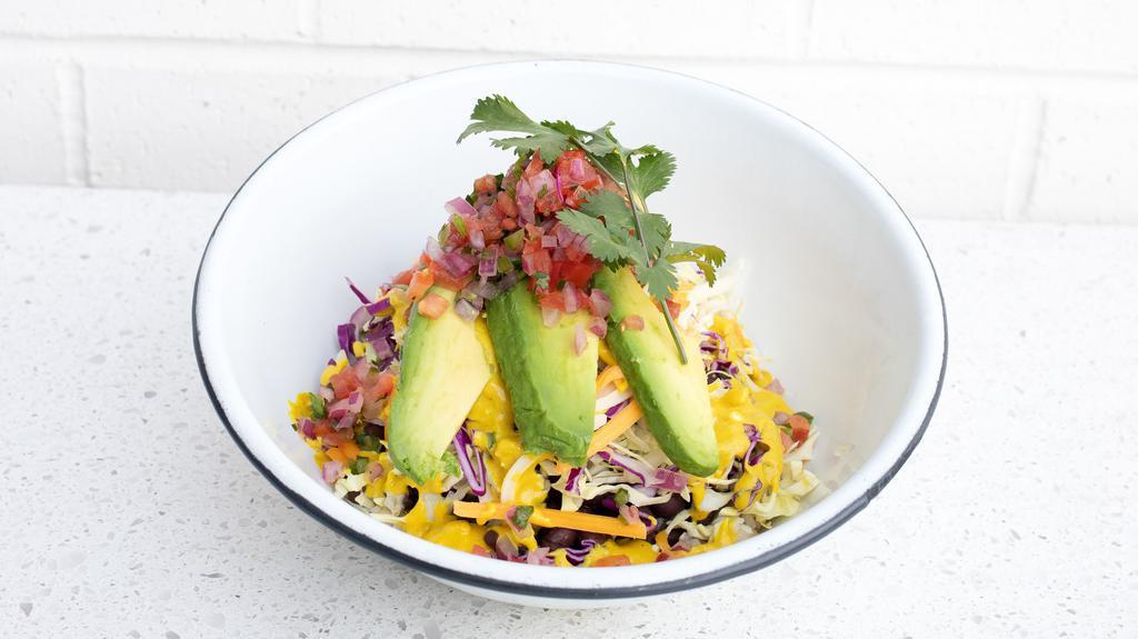 Bender Bowl · Brown Rice, Black Beans, Green and Red Cabbage, Monterey Cheddar Cheese Blend, Salsa Fresca, Avocado, Lemon Cashew Dressing, and Cilantro.
