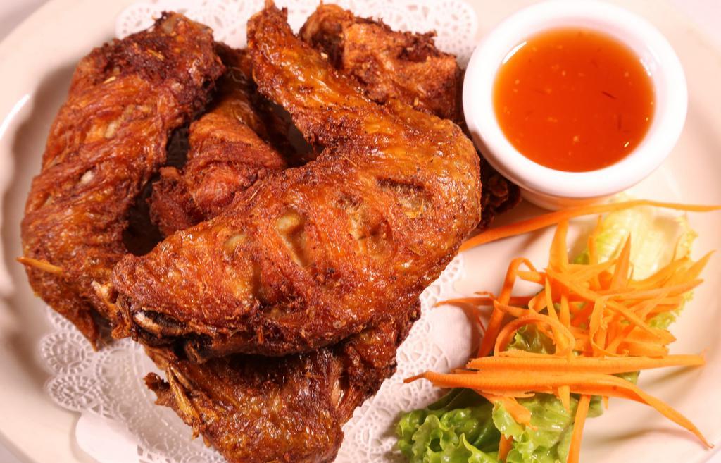Chicken Wings · Marinated with garlic, pepper, and Thai spices, deep fried, and sweet chili sauce.