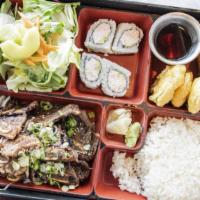 Yakiniku Bento · Tender slices of marinated beef ribeye sautéed with slivers of onions and green onions with ...