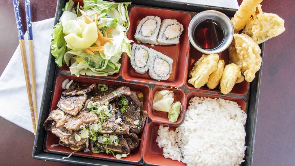 Yakiniku Bento · Tender slices of marinated beef ribeye sautéed with slivers of onions and green onions with a hint of ginger and garlic.