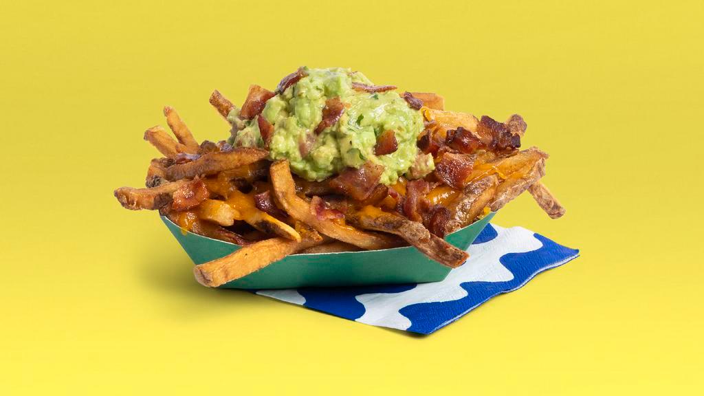 Bacon Guac Fries · French fries topped with guacamole, bacon bits and shredded cheese.