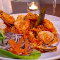 Arroz Con Mariscos · Seafood rice, aji panca pepper, aji amarillo pepper, white wine, shrimp, calamari, octopus, ...