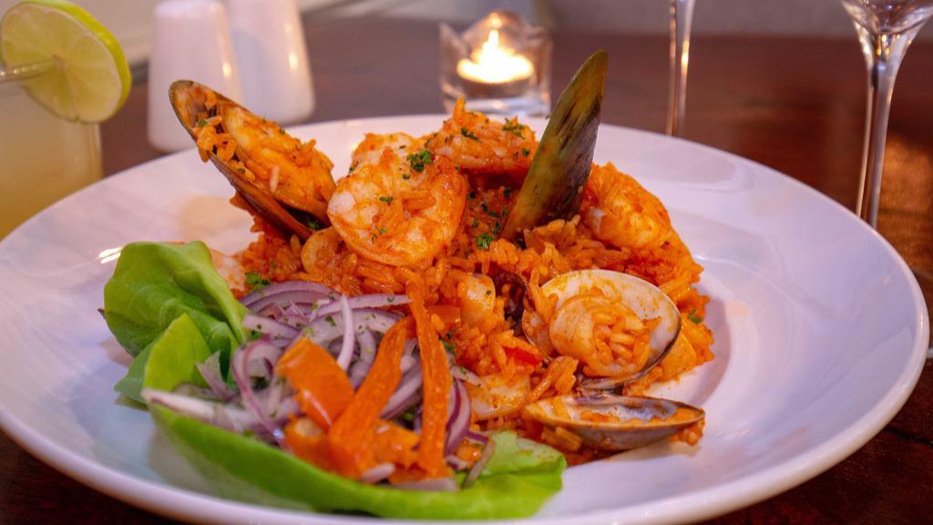 Arroz Con Mariscos · Seafood rice, aji panca pepper, aji amarillo pepper, white wine, shrimp, calamari, octopus, mussels, salsa criolla