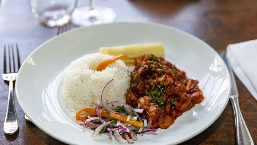 Carapulcra · Peruvian papa seca and pork, chicken, and beef stew, peanut, aji panca pepper, cinnamon, cloves. Served with white garlic rice. **Do not order if you have a nut allergy.**