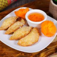 Crab Wonton · Four pieces. Fried crab wonton. Served with sweet and sour sauce.