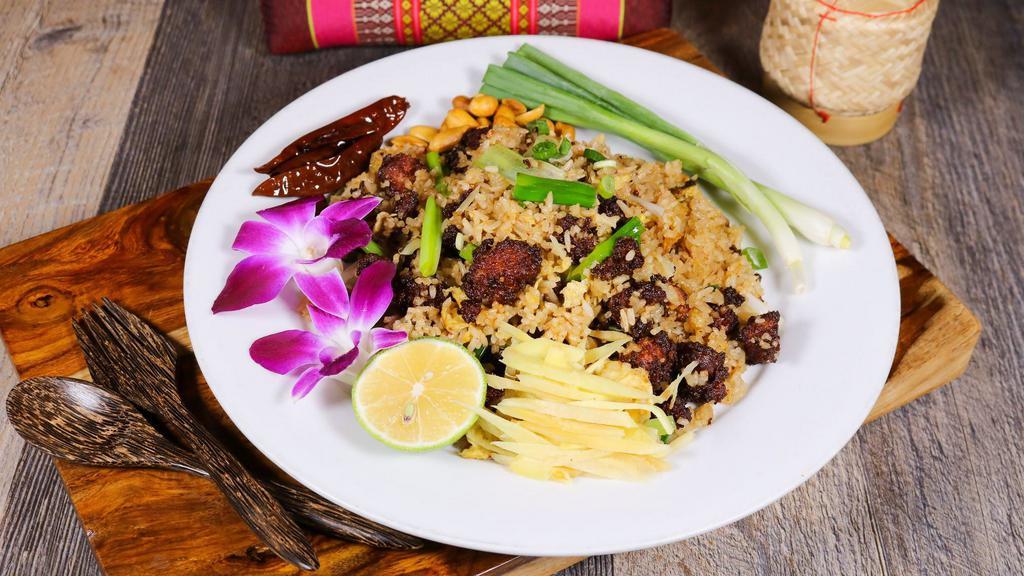 Thai Sausage Fried Rice · Thai jasmine rice sauteed with Thai style sausage, egg, green onion and topped with fresh ginger and peanuts.