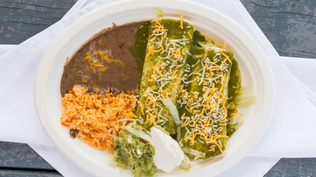 Enchilada Plate · Two enchiladas, red or green salsa, cheese, meat served with rice, beans, sour cream and guacamole.