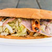 Torta Cubana · White bread with mayo, guacamole, lettuce, tomatoes, onions, jalapeño, cheese, ham, bacon, c...