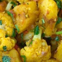 Alu Gobi · Cauliflower and potatoes come together with fragrant spices like turmeric, coriander and cum...