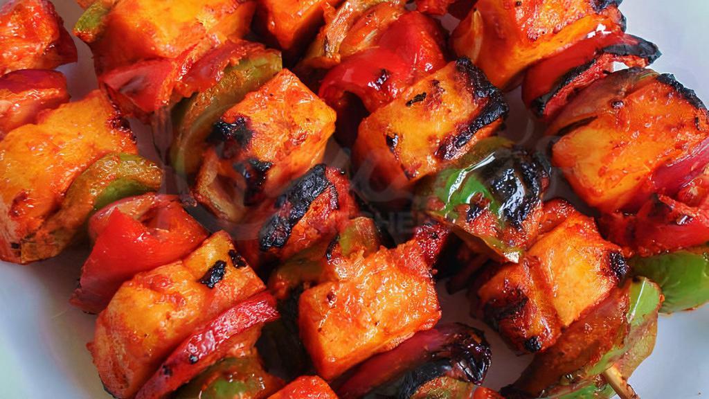 Paneer Tikka · Indian Cottage Cheese (Paneer) & veggies marinated in a super flavorful tandoori masala and grilled to perfection in traditional tandoor (clay oven with charcoal).
Served with mint chutney