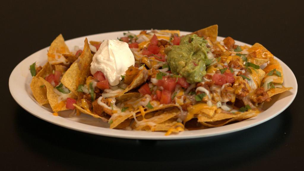 Nachos · Chips with choice of meat, melted cheese, sour cream, refried beans, guacamole, and topped with pico de gallo.