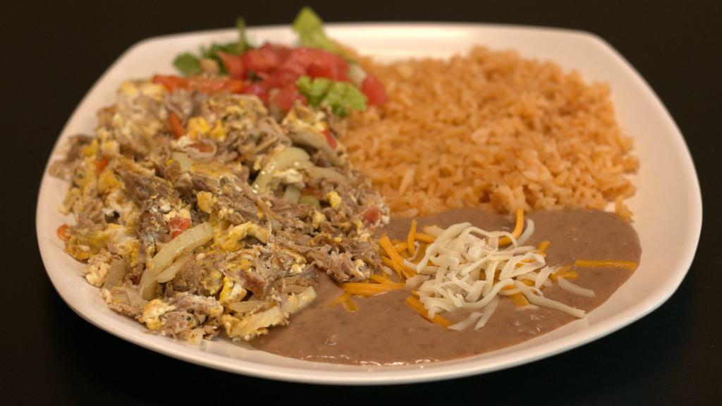 Machaca · Roasted pork cooked with eggs, onions, tomatoes, and bell peppers. Served along with rice, beans, and tortillas.