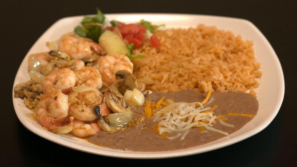 Camarones Al Mojo De Ajo · Prawns and mushrooms sautéed with butter, onions, garlic and spices. Served with rice, beans, and tortillas.
