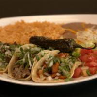 Taco Plate · Three tacos with rice and beans and filled with your choice of meat.