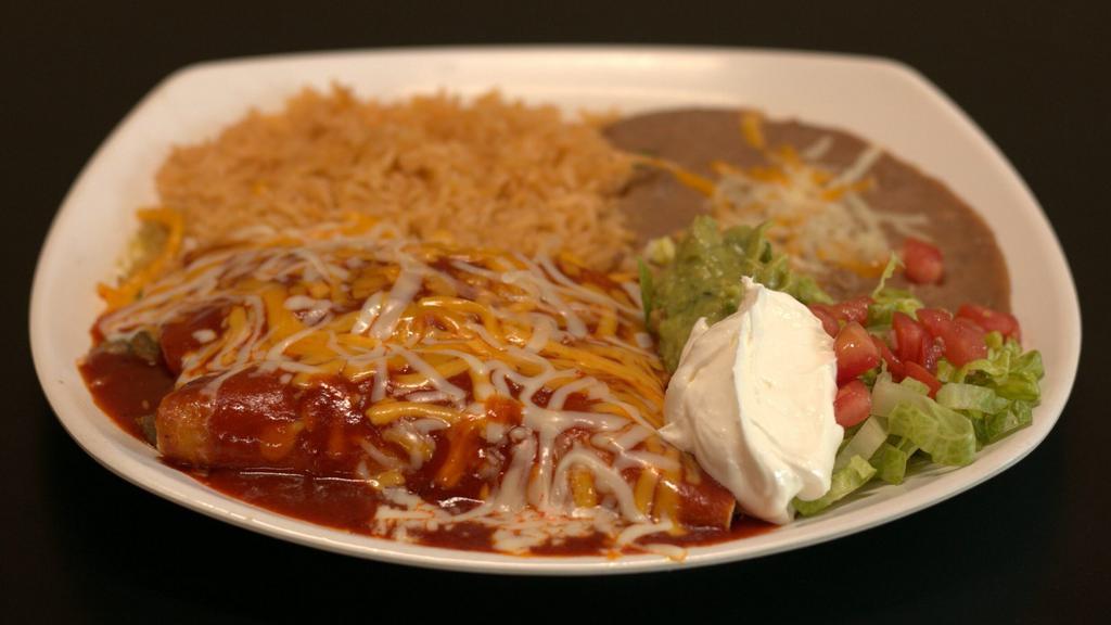 Enchiladas Plate · 2 soft tortilla filled with choice of meat, topped with melted cheese and enchilada sauce. Served with rice and beans.