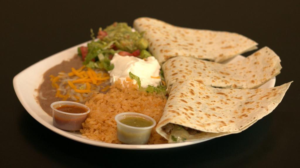 Quesadilla Plate · A flour tortilla with fresh melted cheese, choice of meat. Served with rice, beans, sour cream, and guacamole.